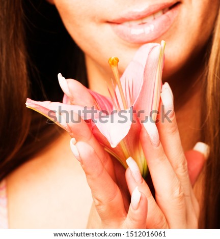 close up photo of woman hands holding flower lily