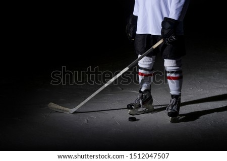 Hockey players legs close-up during a game on ice