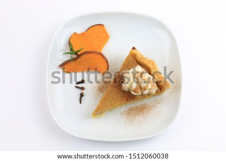 A slice of homemade traditional american sweet pumpkin pie isolated on white background. Top view
