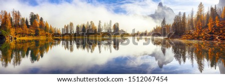 Dramatic foggy autumn landscape. View on Federa Lake early in the morning at autumn. Location: Federa lake with Dolomites peak, Cortina DAmpezzo, South Tyrol, Dolomites, Italy, Europe Royalty-Free Stock Photo #1512067454