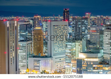 Umeda Central Business District. Aerial Osaka Cityscape at Night shot from one of the tallest building in Osaka named Umeda Sky Building with Road Traffic. The most famous observation deck of Osaka.