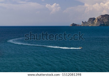 Water scooter with a passenger rushing through the sea