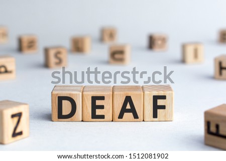 Deaf - word from wooden blocks with letters, unable to hear deaf concept,  white background