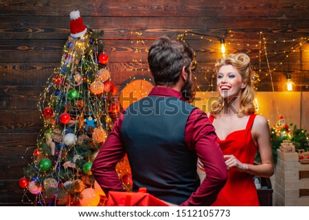 Surprised Christmas couple. Beauty Fashion couple With Christmas Present Box. Excited and happy emotions