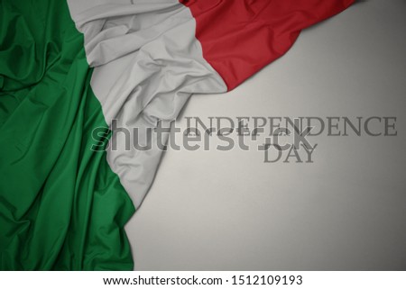 waving colorful national flag of italy on a gray background with text independence day. concept