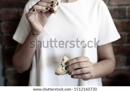Happy girl showing a cookie