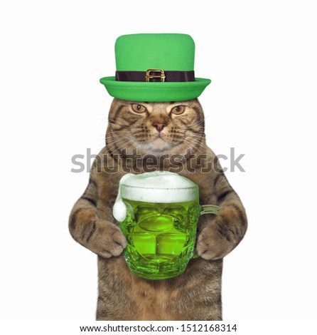 The cat in green hat with a mug of beer celebrates St. Patrick's Day. White background. Isolated.