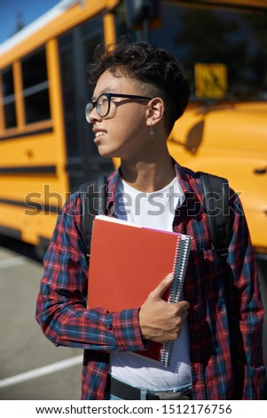 Happy Asian guy holding notebook stock photo