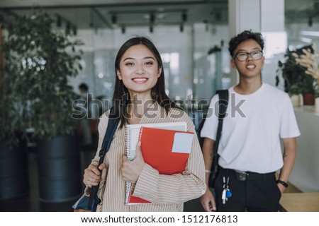 Happy students walking in coffee house stock photo