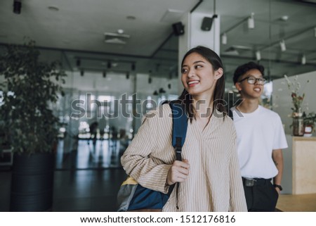 Smiling students standing in coffee house stock photo