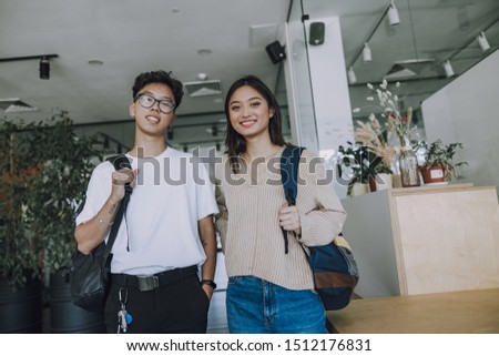 Happy Asian students with backpacks stock photo
