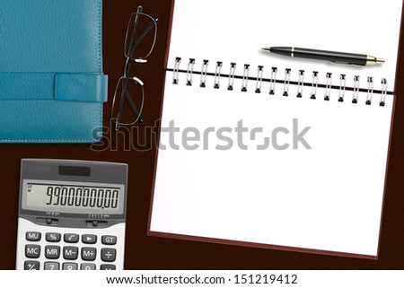 blank brown notebook with stationery on the desk for your text