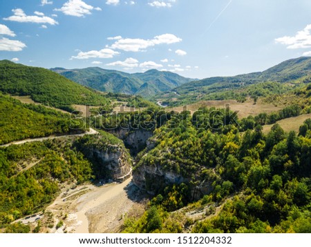 aerial picture of Osumi river canyon in the town of Skrapar in Albania shows the huge wide canyons and the river floating in between the cliffs. this is one of the best places to experience nature 