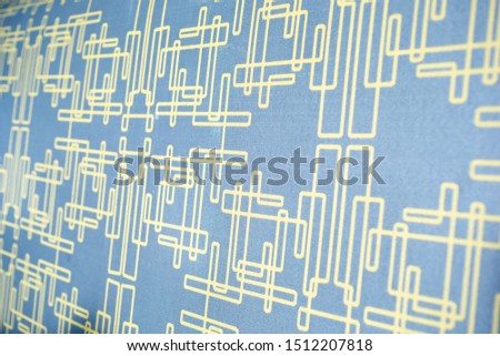 A view of abstract circuitry shapes and lines on fabric.