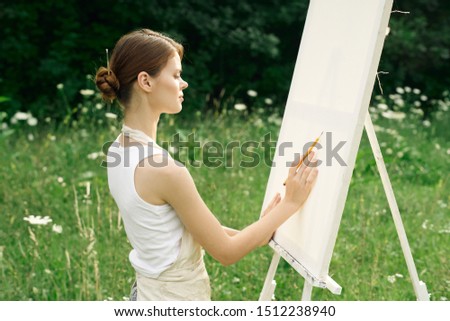 beautiful woman artist holds pencil
