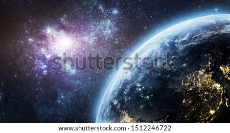 Nightly planet Earth in the outer space. Nebula. Abstract wallpaper. View from Space station. City lights on planet. Civilization. Elements of this image furnished by NASA