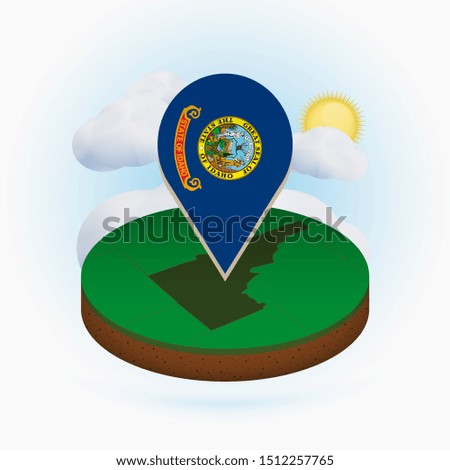 Isometric round map of US state Idaho and point marker with flag of Idaho. Cloud and sun on background. Isometric vector illustration.