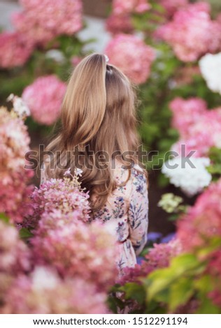 Girl with long hair in flowers. Nice beautiful photo.