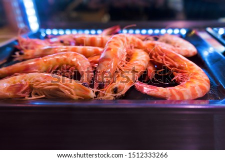 Fresh king shrimp in street market. Colorful fresh king prawns. Crustacean in night food market.