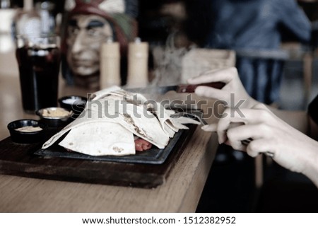 A young woman eats a tasty fresh Indian meals