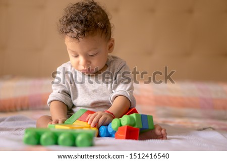 Child playing with colorful toys.  Royalty-Free Stock Photo #1512416540