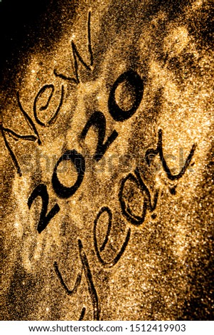 Happy New Year 2020. Beautiful sparkling Golden number 2020 on black background for design With Copy Space For Text. Beautiful Glowing overlay template for holiday greeting card.