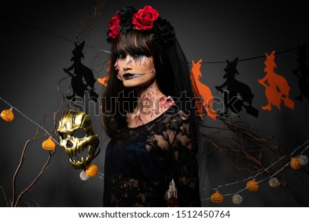 Zombie woman with Wound on face black hair red rose dress as scary and want to revenge kill all of Haunted places, halloween background with witch and pumpkin garland hanging