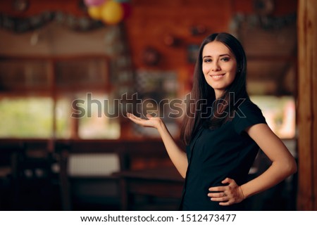 Manager Standing in a Restaurant Welcoming Customers. Confident self-employed female entrepreneur greeting guests 
