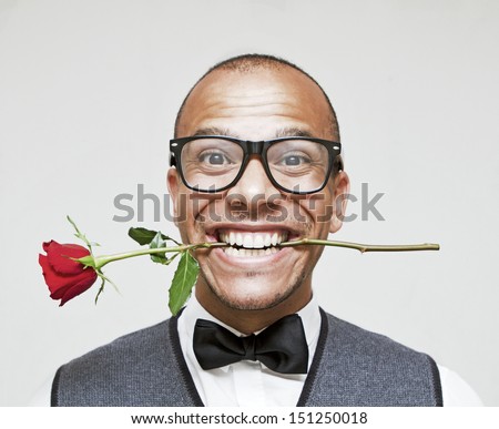 Romantic Geek in Love, holding a rose between his teeth excitedly Royalty-Free Stock Photo #151250018