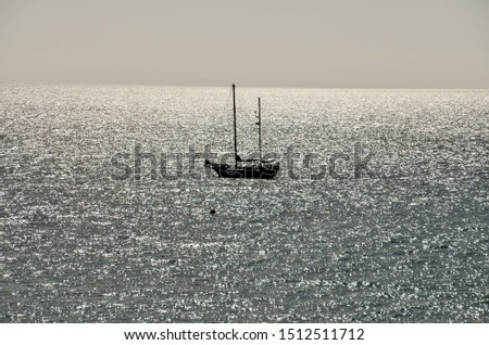 Backlight Picture of a Silhouette Boat in the Ocean