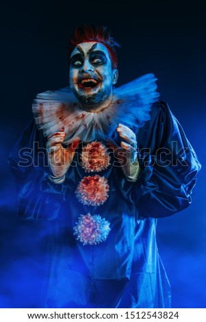 A portrait of a laughing crazy clown from a horror film. Halloween, carnival.