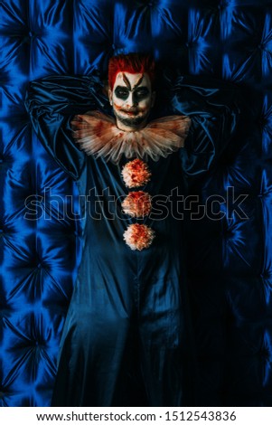A portrait of an angry clown from a horror film. Halloween, carnival.