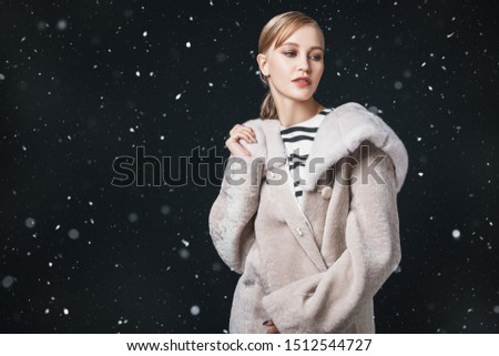 A portrait of a young fashionable woman in a white mink coat. Beauty, fashion.