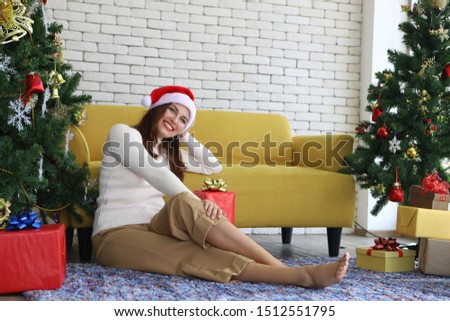 beautiful  woman in  Christmas sits on the floor  near the  xmas trees,  new year gifts. 