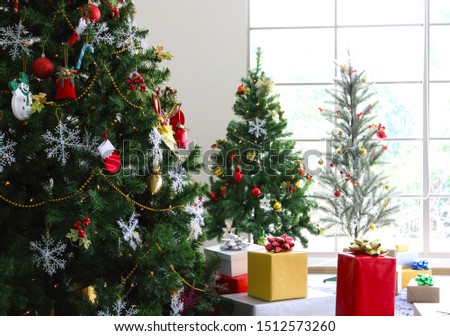 closeup image of Christmas tree with presents in the room
