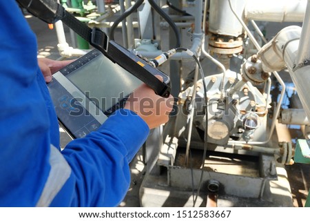 Mechanical engineer use vibration meter to measurement of centrifugal pump vibration and electric motor at oil and gas plant or chemical factory. Royalty-Free Stock Photo #1512583667