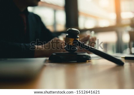 Mature couple signing contract in lawyer's office (meeting concept)