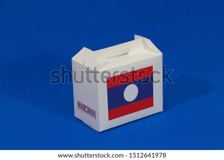Laos flag on white box with barcode and the color of nation flag on blue background. The concept of export trading from Laos, paper packaging for put products.