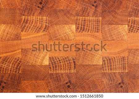 Background texture of wood Board surface. The brown wooden plank has the effect of a chessboard. The mosaic consists of different cuts of wood.
