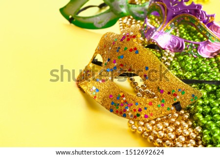 Festive masks with decor on color background