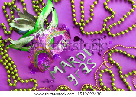 Composition for celebration of Mardi Gras (Fat Tuesday) holiday on color background