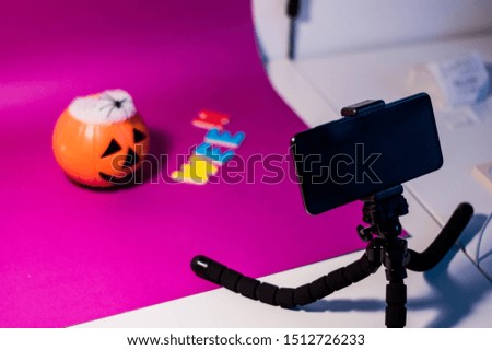 Photography of a table with halloween objects prepared to be photographed by a mobile phone for a stock session.
