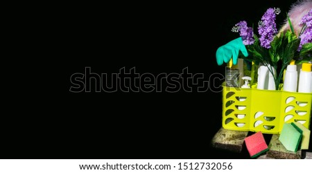 Bucket or basket with cleaning items in wooden board and black background with copy space Washing set banner.