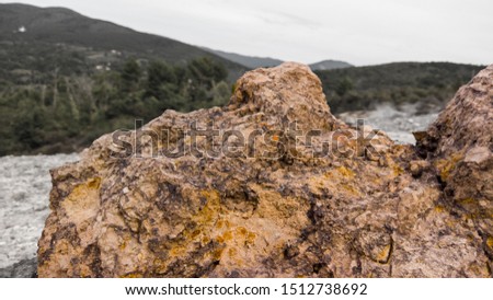 Rock in the foreground with hills in the background
