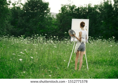 woman in shorts with canvas and paints