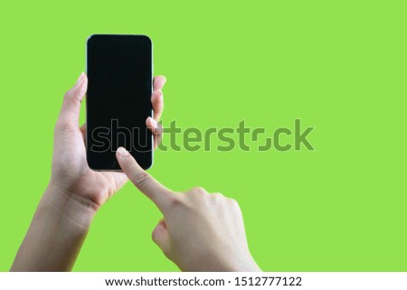 Hands and phones on a green background New technology of smart phones