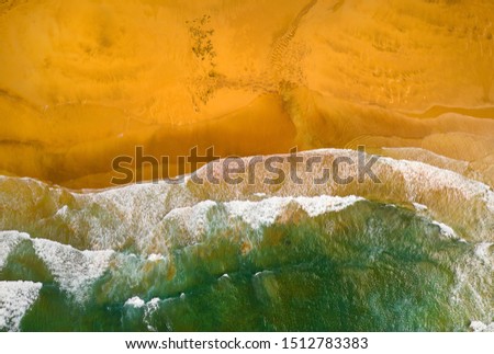 Aerial view of tropical ocean meeting the sand