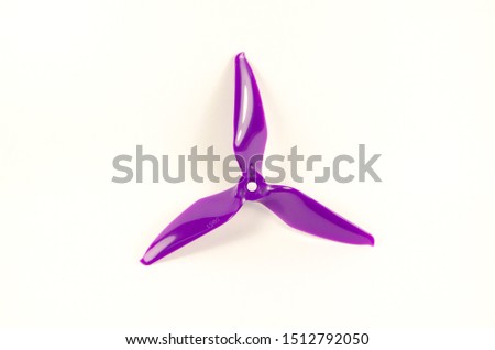 Closeup of quadcopter or drone propeler for freestyle or racing drone. 5051 3 blade propellers in purple taken in high key
