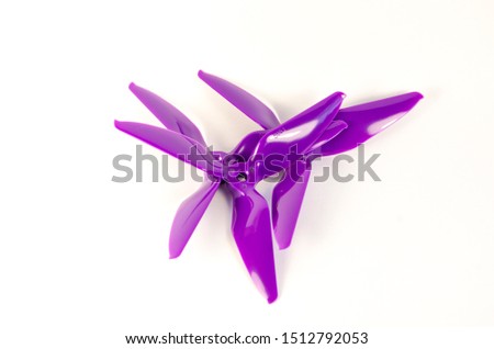Closeup of quadcopter or drone propeler for freestyle or racing drone. 5051 3 blade propellers in purple taken in high key