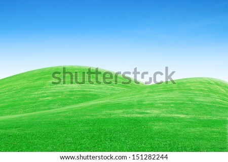 green grass hills with blue sky